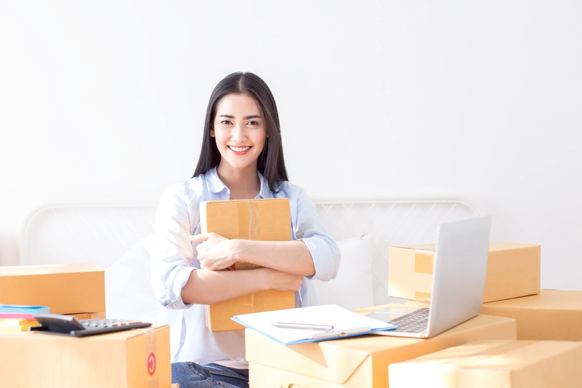 Young asian woman business owner work and white down address for deliver at home, woman business owner concept, 20-25 year old.